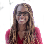 Jamie smiles in her headshot. She's wearing a magenta blouse and is in front of a white background.